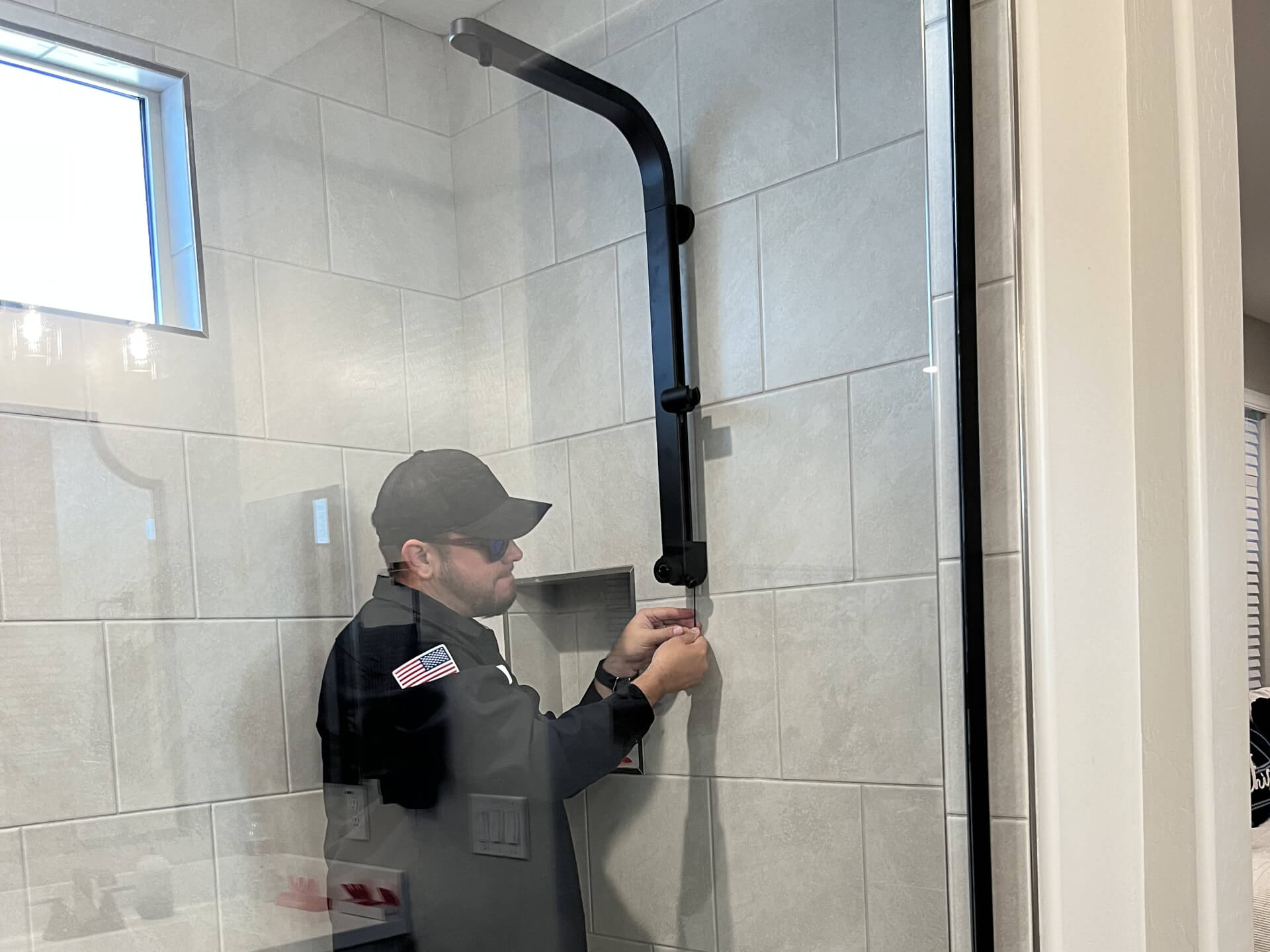 Target Plumbing employee fixing a shower head