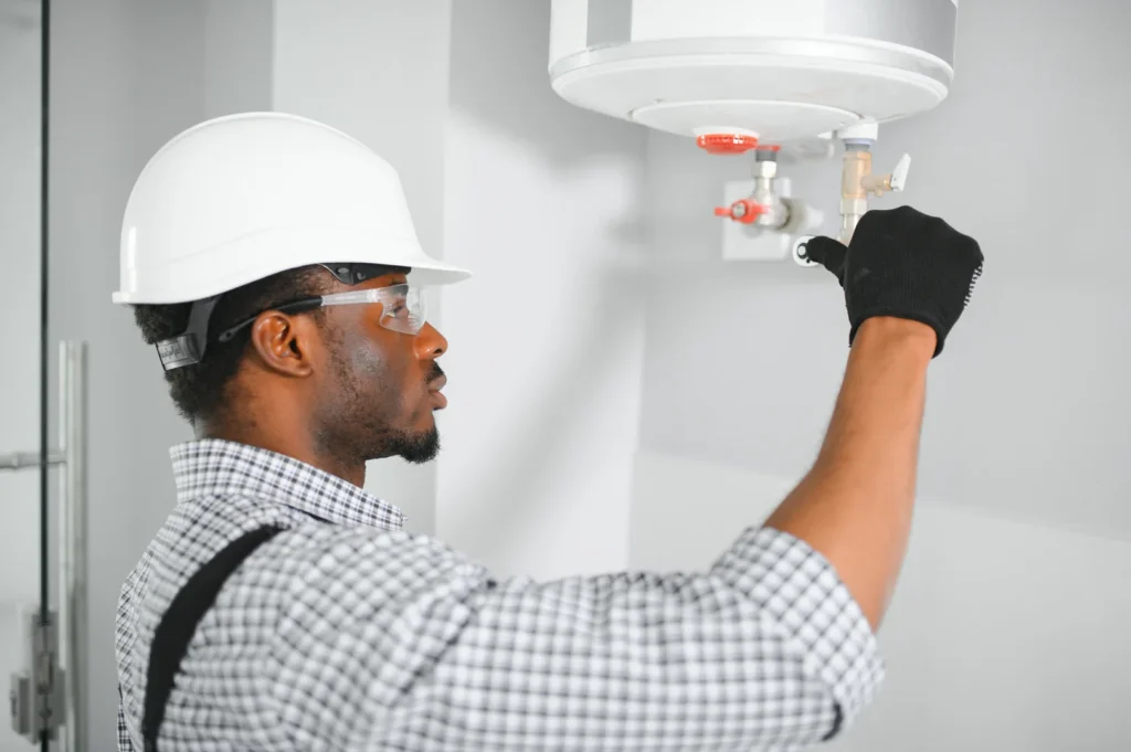 A plumber performing maintenance on a tankless water heater