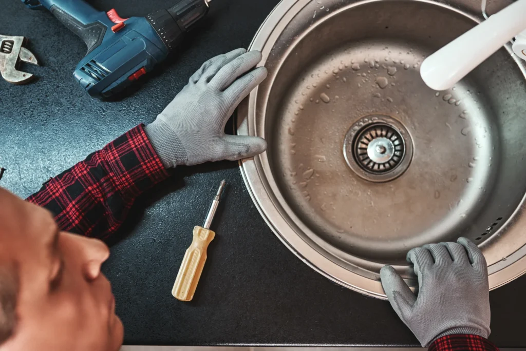 A Plumber in the process of inspecting a drain