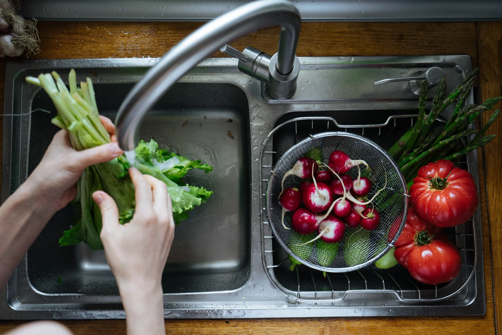 Washing Veggie in a sink with a garbage disposal