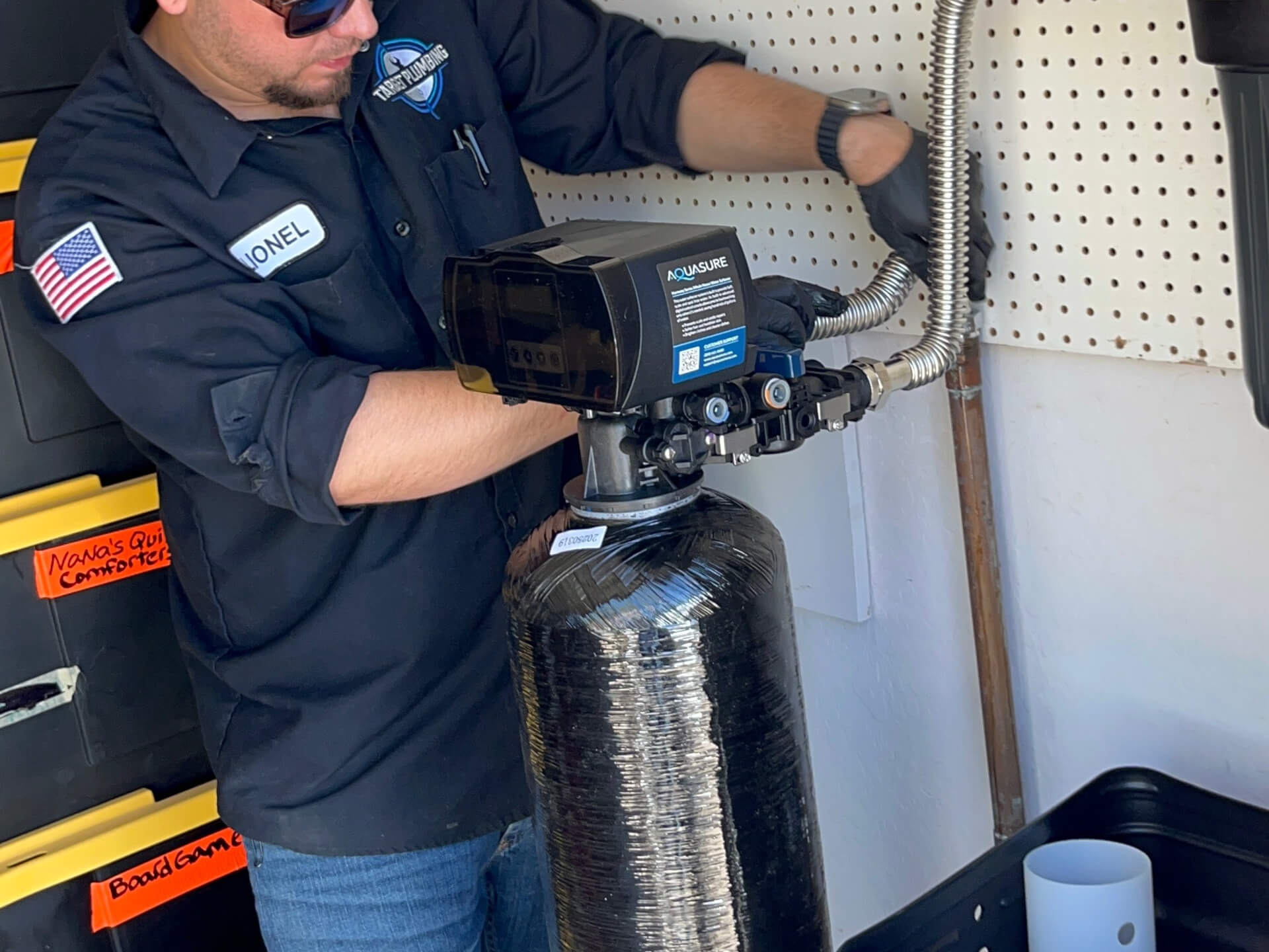 A target plumbing employee installing a new water softener