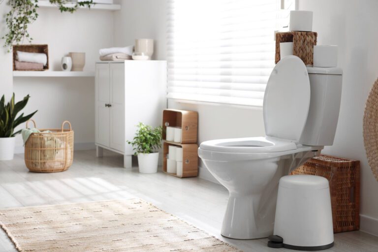 A toilet in a white modern bathroom