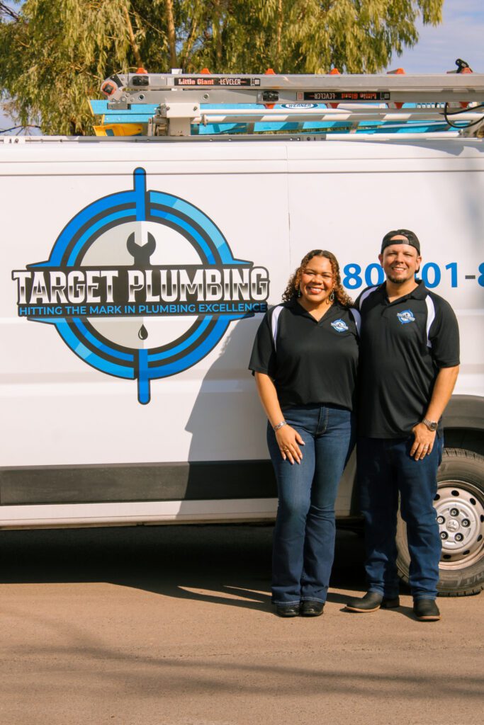 Kebra & Lionel Standing in front of a Target Plumbing Van